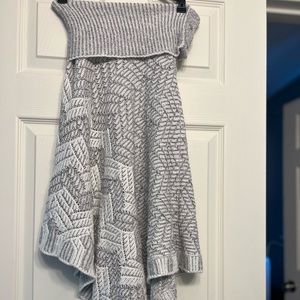 Oversized petite shawl with decorative buttons on the neckline.